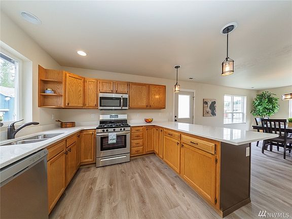 Huge kitchen with all new appliances, gas range, sink, faucet, quartz counters and lighting.