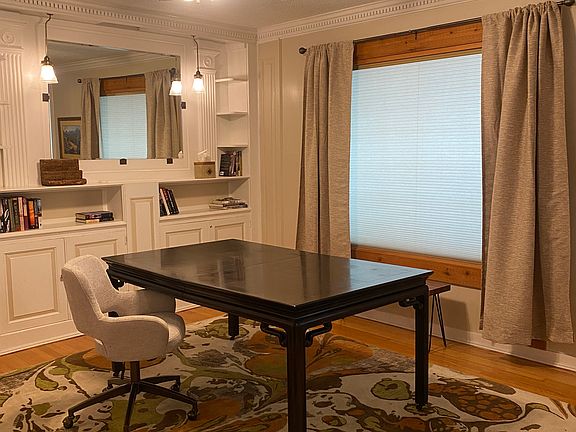 OTHER SIDE OF ROOM SET UP AS OFFICE/READING ROOM/DEN SHOWING SHADE CLOSED- THE BUILT IN BOOK SHELVES FROM THE 1940'S!