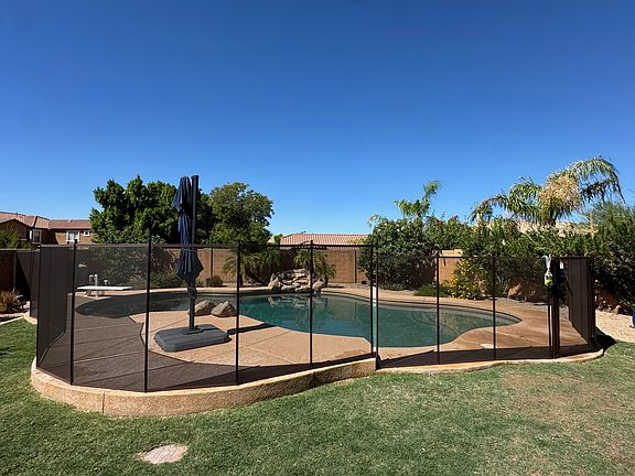 Fenced pool area with pebble-tec pool
