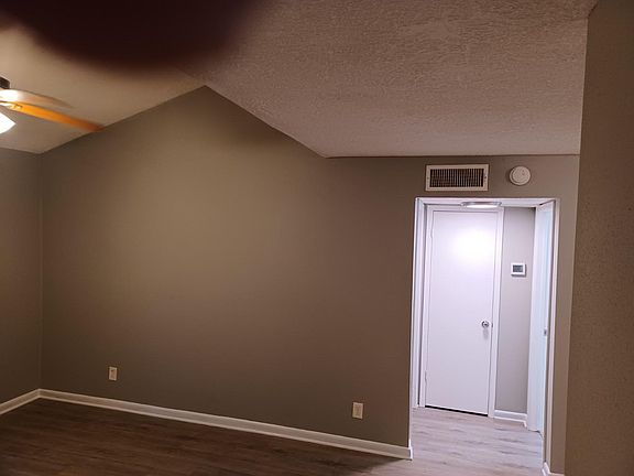 High ceiling picture taken at night. Neutral paint all over provides a perfect canvas for your timeless works of art.