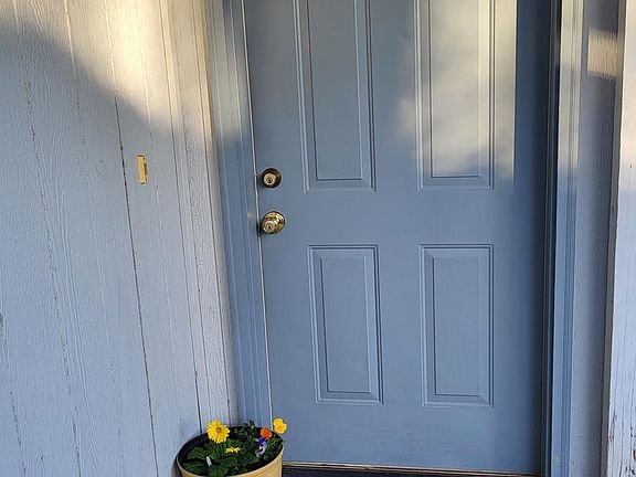 front door with a front patio