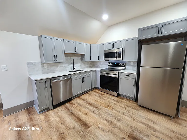 Kitchen with Soft-Close Cabinets, Stainless Steel Appliances, Granite Countertops and Stylish Tile Backsplash