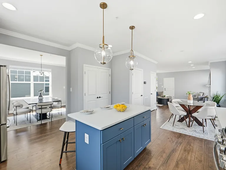 Chef's kitchen with island, farmhouse sink, herringbone backsplash, gas range, and breakfast nook.
