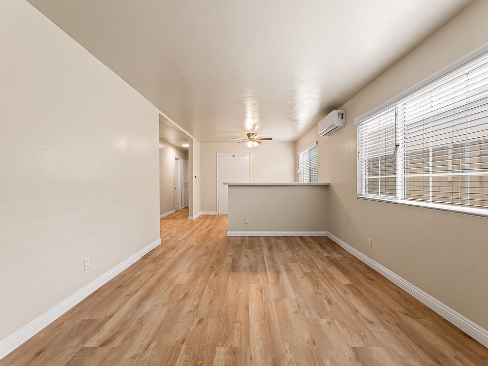 Upon entry is the Living Room with Laminate wood floors, freshly painted and sub divided blinds