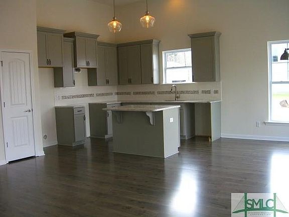 KITCHEN WITH GRANITE COUNTER TOPS, 42" UPPER CABINETS, TILE BACKSPLASH, AND ISLAND.  STAINLESS STEEL APPLIANCES TO BE INSTALLED 