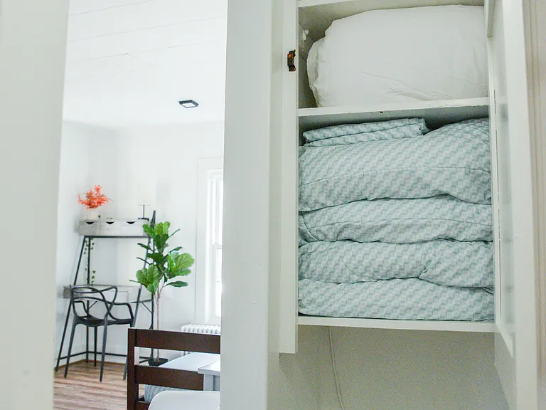 Pillows, blankets are stored here for the sofa bed