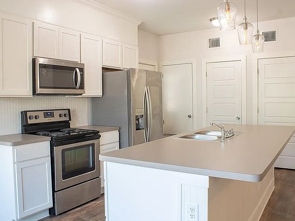 Kitchen with Bar-style seating has pantry and ample storage