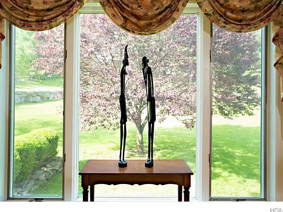 Simple elegance stands amidst flowering trees