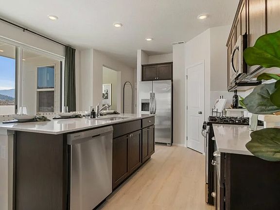 The center island extends out to a breakfast bar for casual meals (Model Home Images)