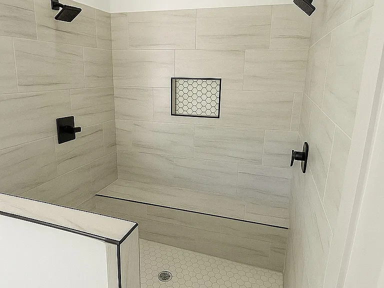 Step into your perfect private retreat _ a spacious master bath featuring double shower heads, a built-in resting bench, and sleek modern finishes. Designed for both comfort and style, this spa-inspired space offers the ideal place to unwind and recharge.