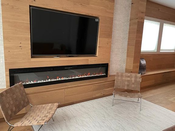 Living Room Area with Build in 75 inch Smart TV and Sleek 100inch Electric Fire Place