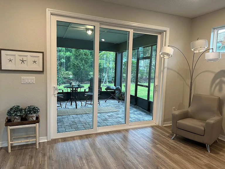 Triple glass slider invites the preserve views to be enjoyed- Grab your wine and relax on the screened paver lanai pre plumed for gas grilling!