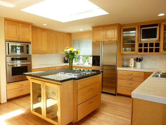 Large double skylight above the granite topped cooking island with bar seating.