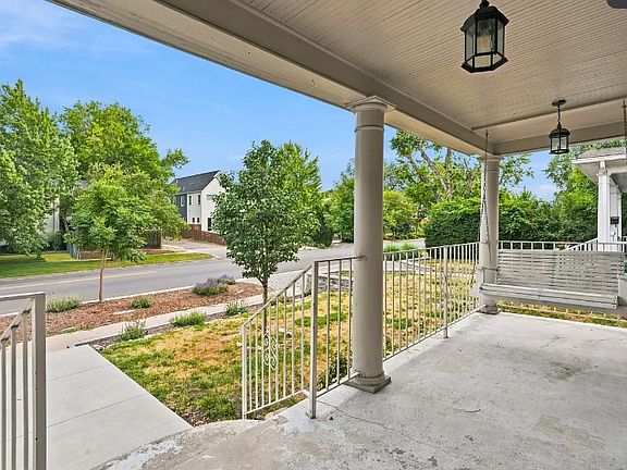 Unfurnished porch but does have a small bistro table with two chairs on it along with the porch swing. Add some flower boxes, rug, pillows and its beautiful!