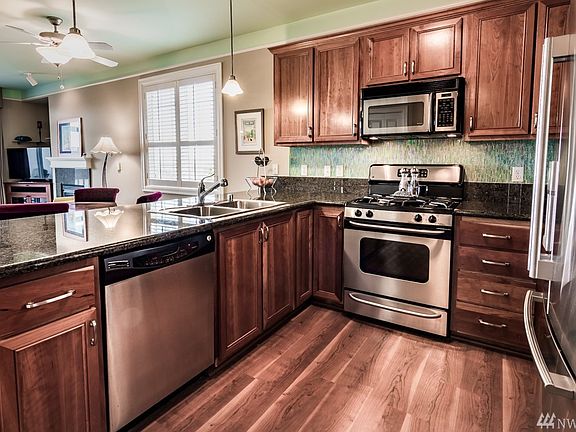 Beautiful chef's kitchen with stainless steel appliances, cherry cabinets and granite counter tops as well as granite backsplash.