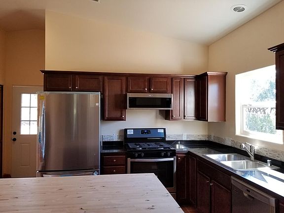 High ceilings, cherry wood cabinets with black granite counter-tops & stone back splash with stunning amenities with stainless steal appliances; LG fridge w/lots of storage space and organization bins and drawers, large and deep bottom freezer provides ex