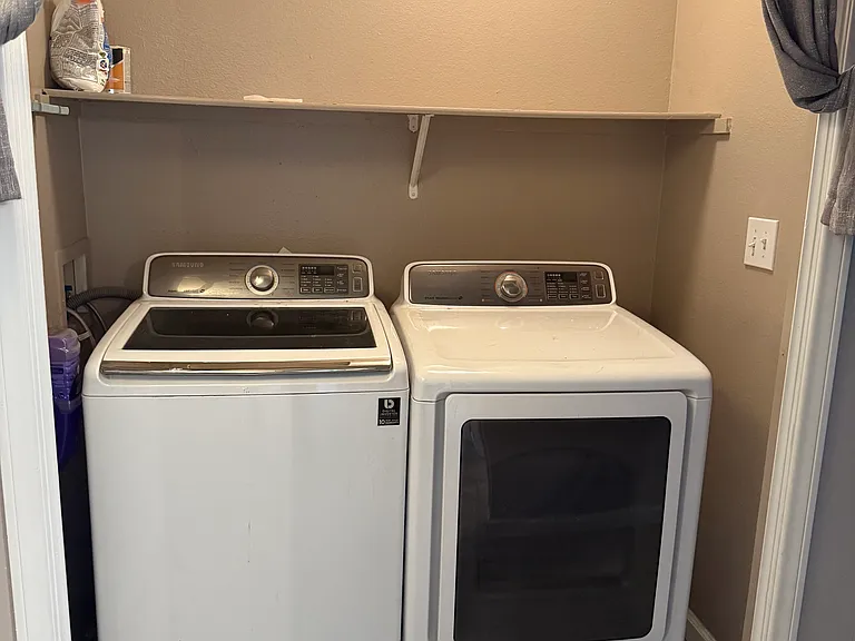 Washer & Dryer in hall with curtain drape covers.