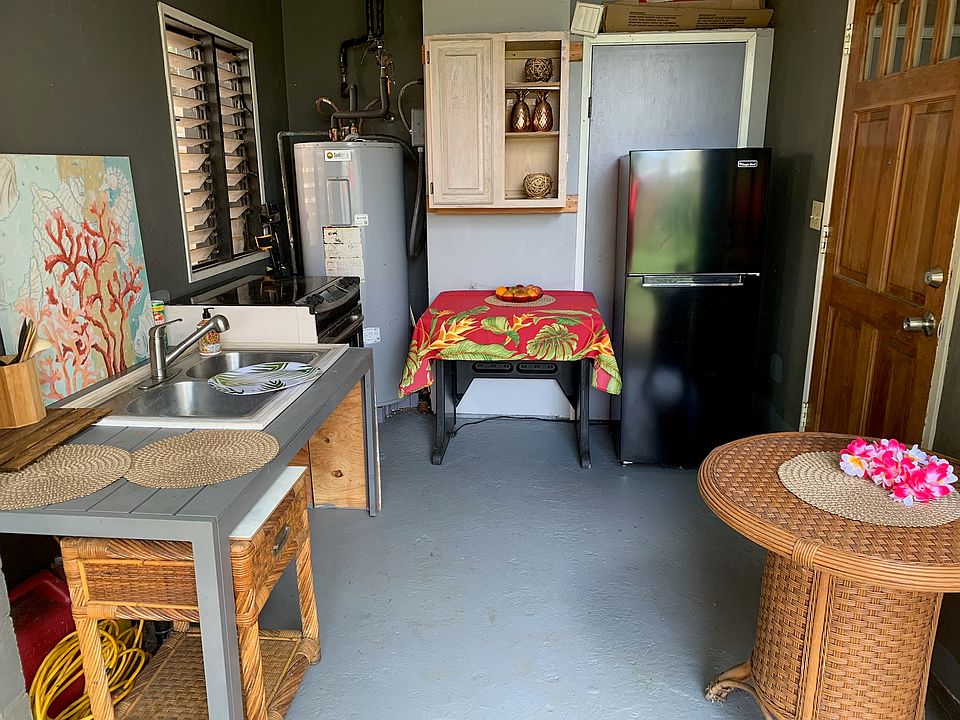 Modified wet kitchen, with refrigerator, sink and stove.