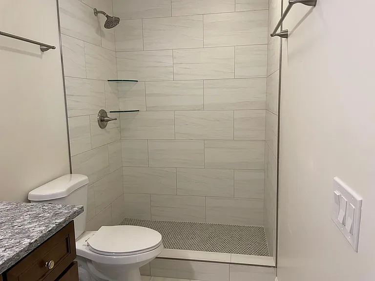 Beautiful, spacious updated walk-in shower with beautiful, functional, easy to clean ceramic tile.