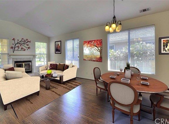 This photo shows the living and dining area virtually staged.