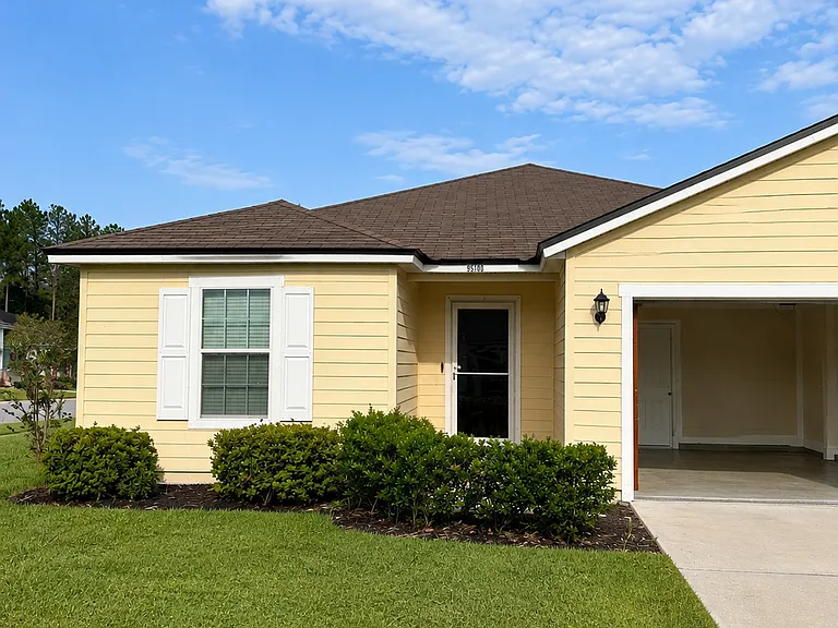 Front of house. easy lawn maintenance and 2 car garage