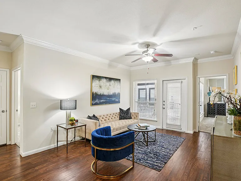 Experience comfort and style in this spacious living room featuring plush carpeting and abundant natural light.