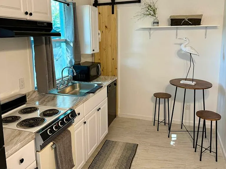 All appliances includes a dishwasher!
Small storage space behind the wooden barn door.