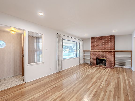 Light and bright. Classic 50's ranch charm. Front entrance, hall closet, built in shelves, wood burning fireplace.