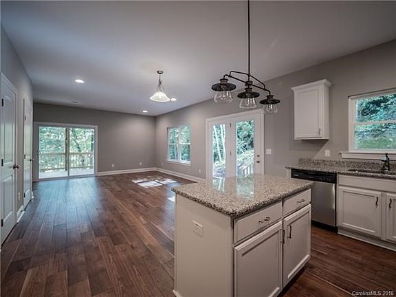 Kitchen and main living opens to screened deck