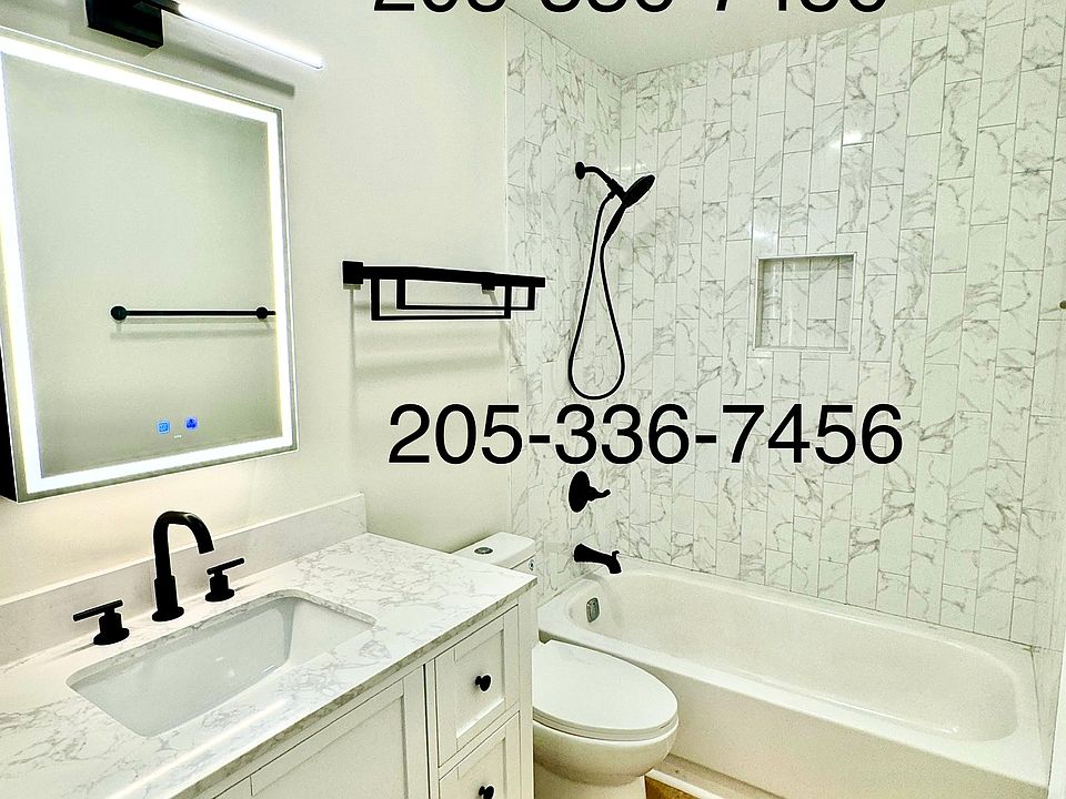 Enjoy a nice bath in the newly tiled bathtub with oversized marble sink, LED mirror with storage and charger, new toilet/fixtures