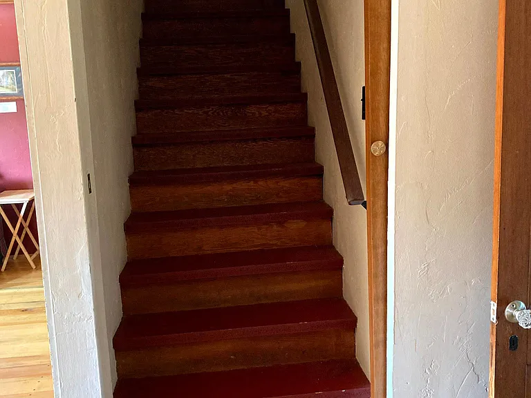 This stairwell is between the living room and the bedroom, with an old fashioned pocket door. If you are sharing this house with another adult or young adult, this door provides some privacy.