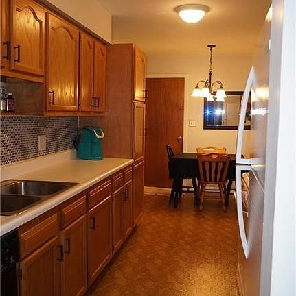 Nice eat in kitchen with backsplash, newer lighting and windows.