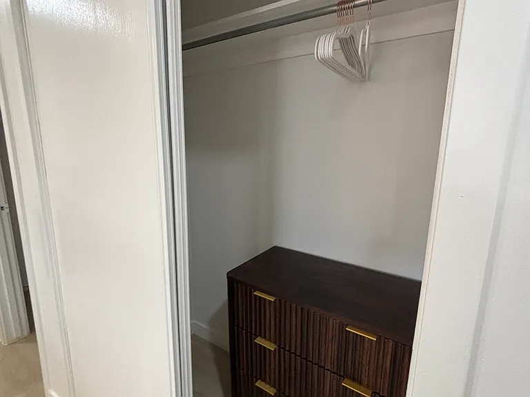 Spacious closet with hanging space and chest of drawers, just off the ensuite bath.