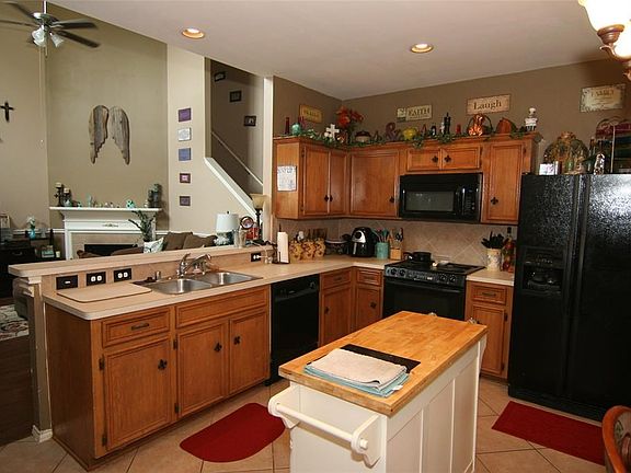 The open plan includes the kitchen bar separating the living room from the kitchen - providing more seating space for family or entertaining.