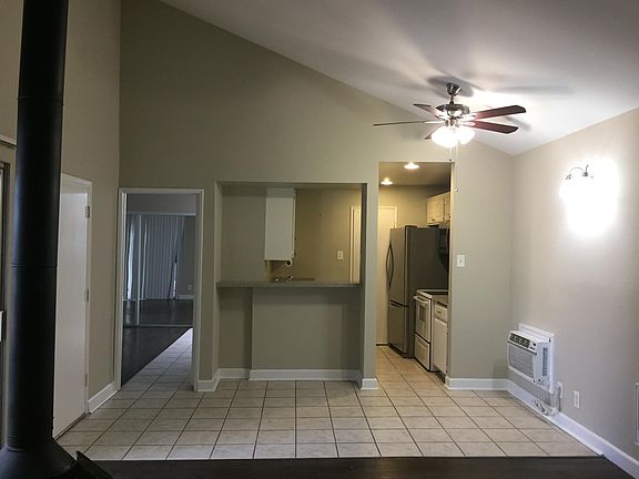 Front door to left.Small bar. Kitchen in background.Original