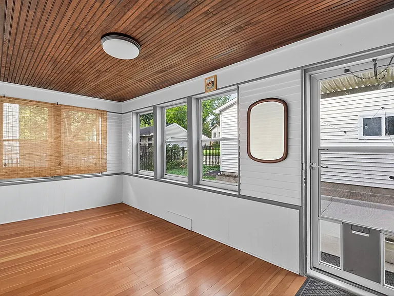 Four-Season Porch/Sunroom, a perfect bonus space for relaxing, working, or enjoying your morning coffee.