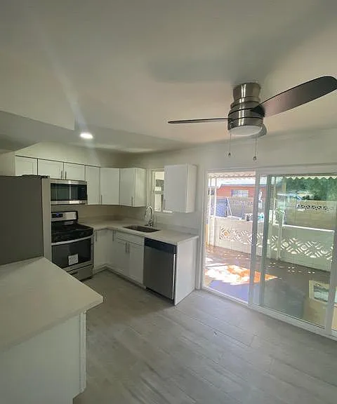 REMODELED KITCHEN WITH STAINLESS STEEL APPLAINESE AND QUARTZ COUNTER TOPS