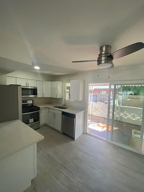 REMODELED KITCHEN WITH STAINLESS STEEL APPLAINESE AND QUARTZ COUNTER TOPS