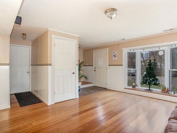This is the front door entering into the family room with bow window, has half bath and closet for storage and door to 2 car oversized garage.