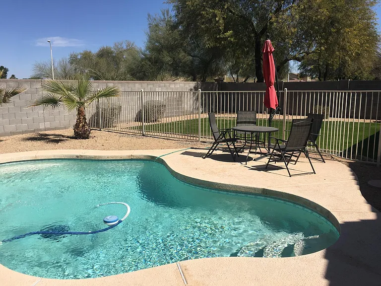 Pool view and yard with patio furniture.