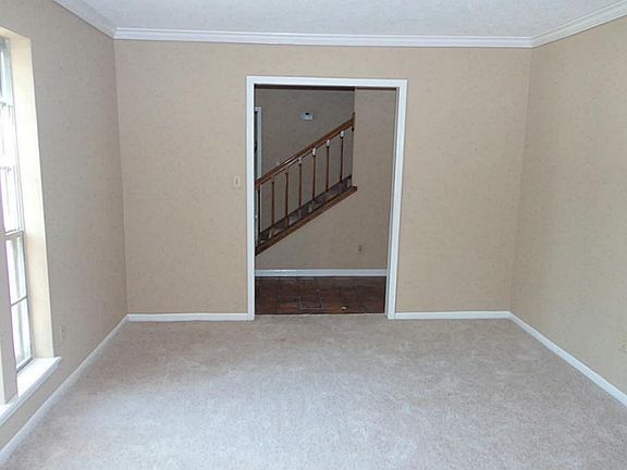 Formal living room with fresh paint and replaced carpet.  Use this area as a DOWNSTAIRS GAMEROOM OR STUDY!