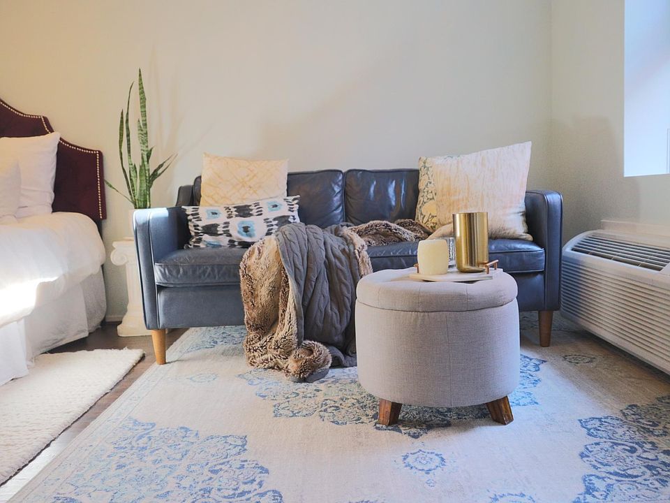 Turn left for the main room -- plenty of room for seating area. Through-the-wall air conditioner and heater, like you''d find in a hotel, saves window space. Pictured here is a 70-inch couch. Wall is over 13 feet.