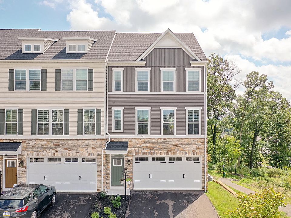 Front View of End Unit Townhome - Shows two car garage and big driveway for additional cars