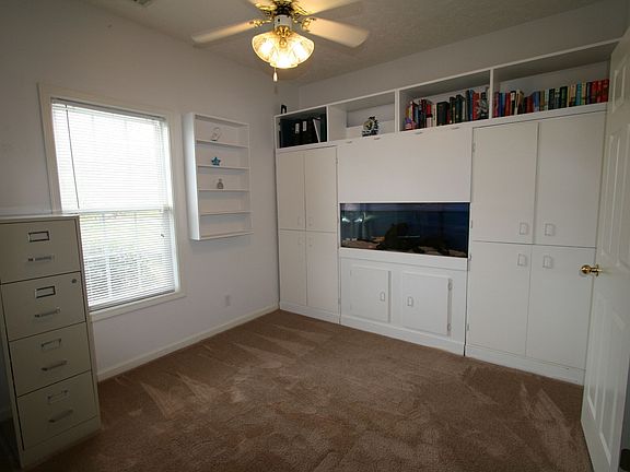 Office with built in bookshelf and aquarium
