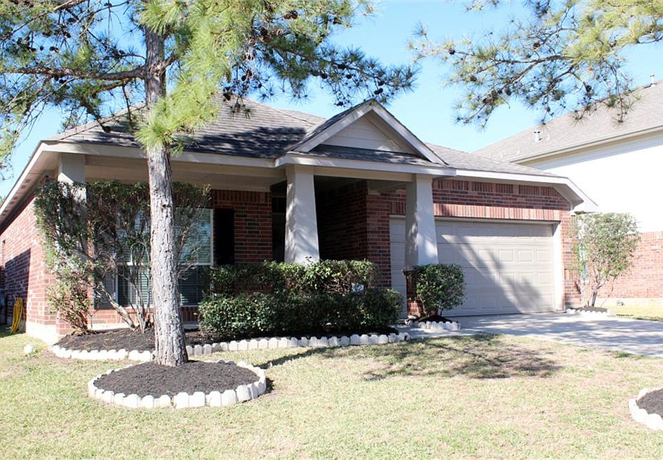 Charming covered front porch elevation with manicured front yard.