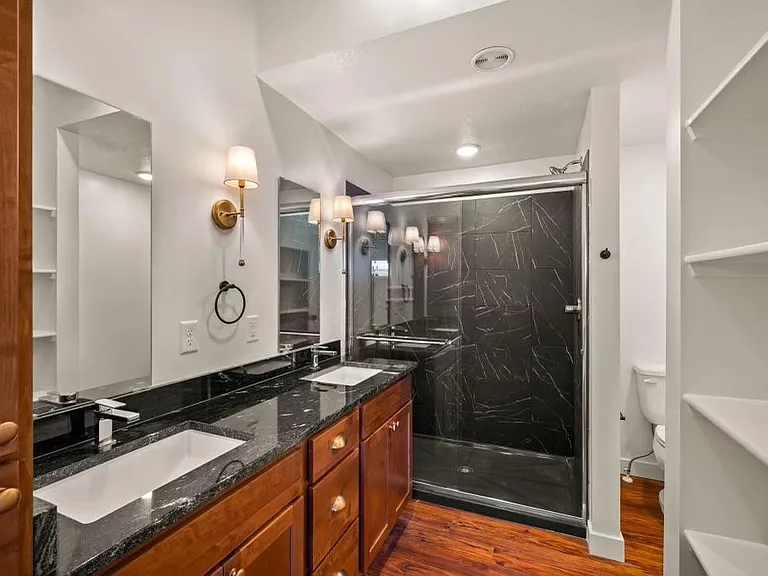 Double Sink, modern shower and plenty of storage in master bath