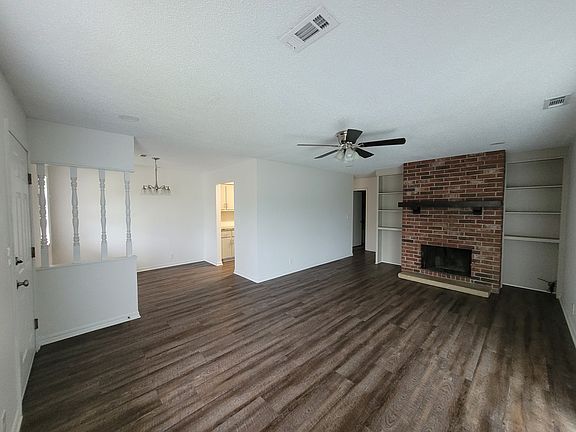 Look from sliding glass door across living area, dining on the right with dining area kitchen entry.