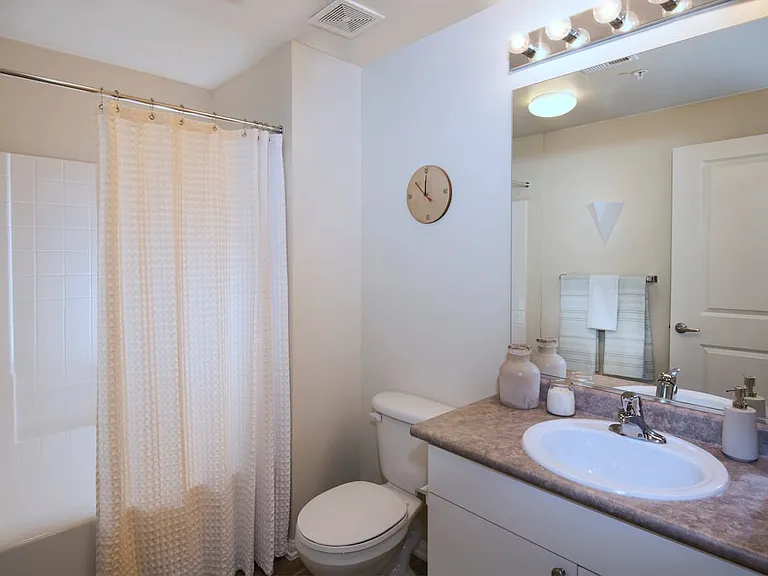 Classic Package I bath with white cabinetry, laminate countertops, and tile flooring