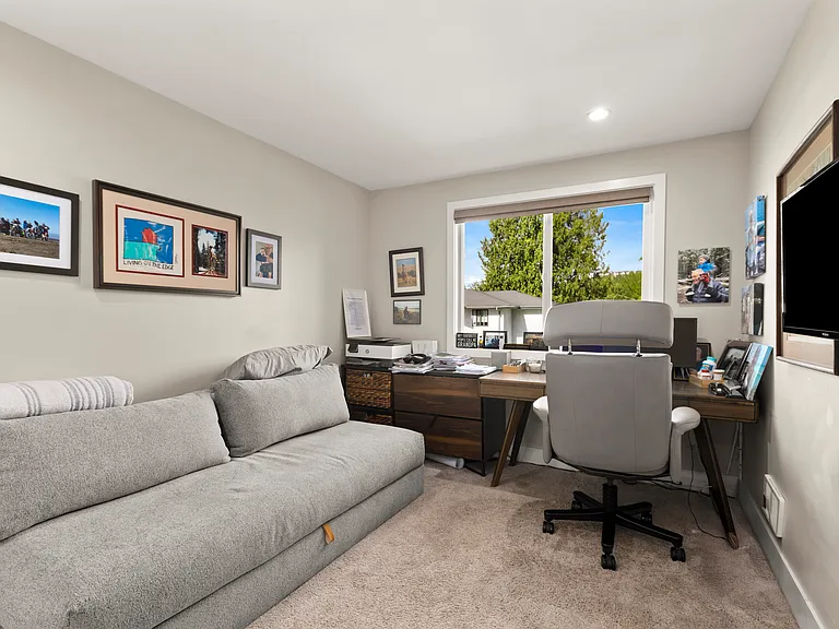 furnished second bedroom/office with queen sleeper sofa