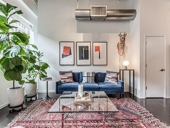 This is a great floor plan! The open Living/Dining/Kitchen gives the feel of a true loft, yet this unit has 2 large separate bedrooms that live like a more traditional home. The best of both worlds! Door seen on right is Kitchen pantry.